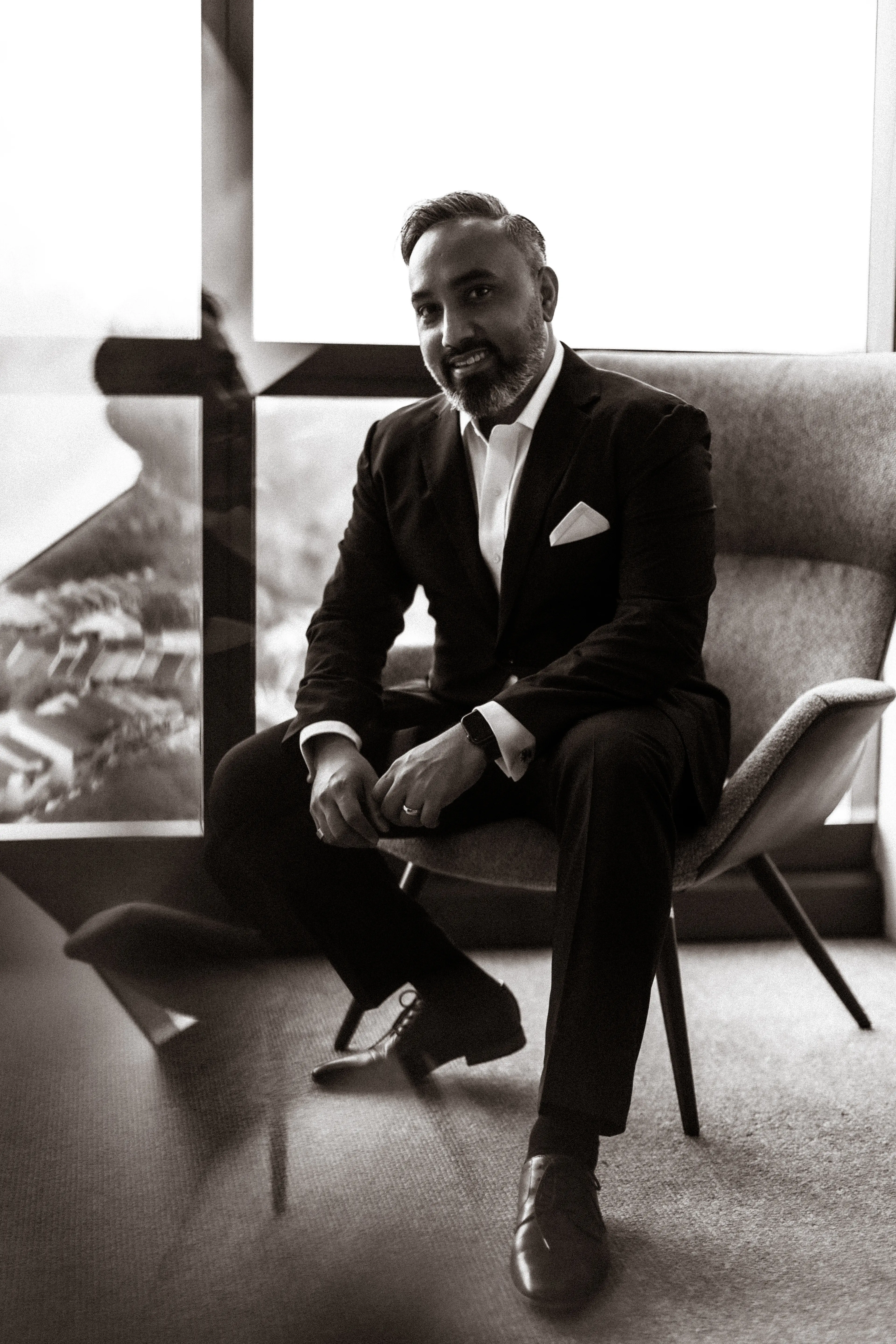 Aaron Sarma seated by a window overlooking Kuala Lumpur